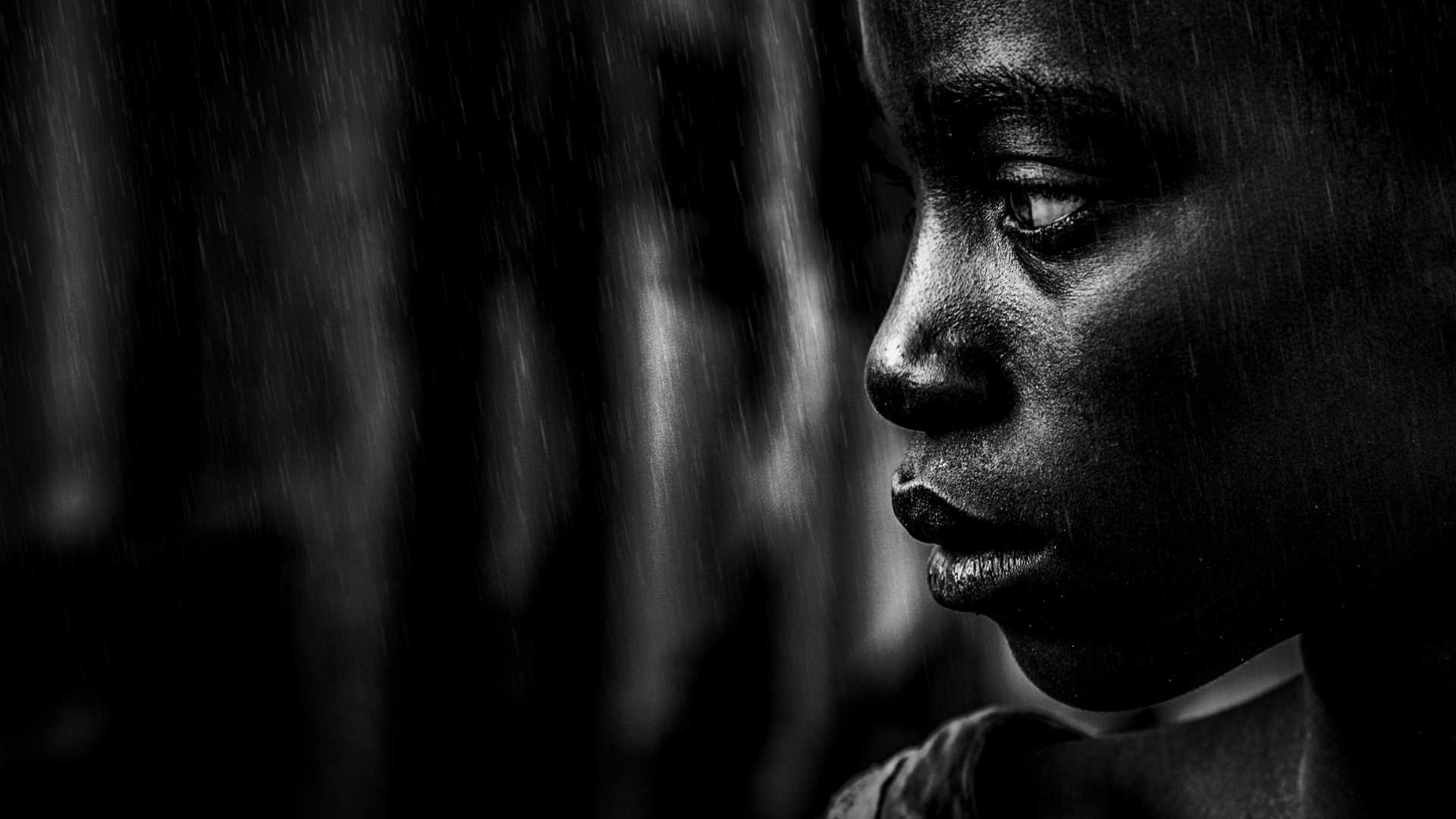 Sad thoughtful child with dark background