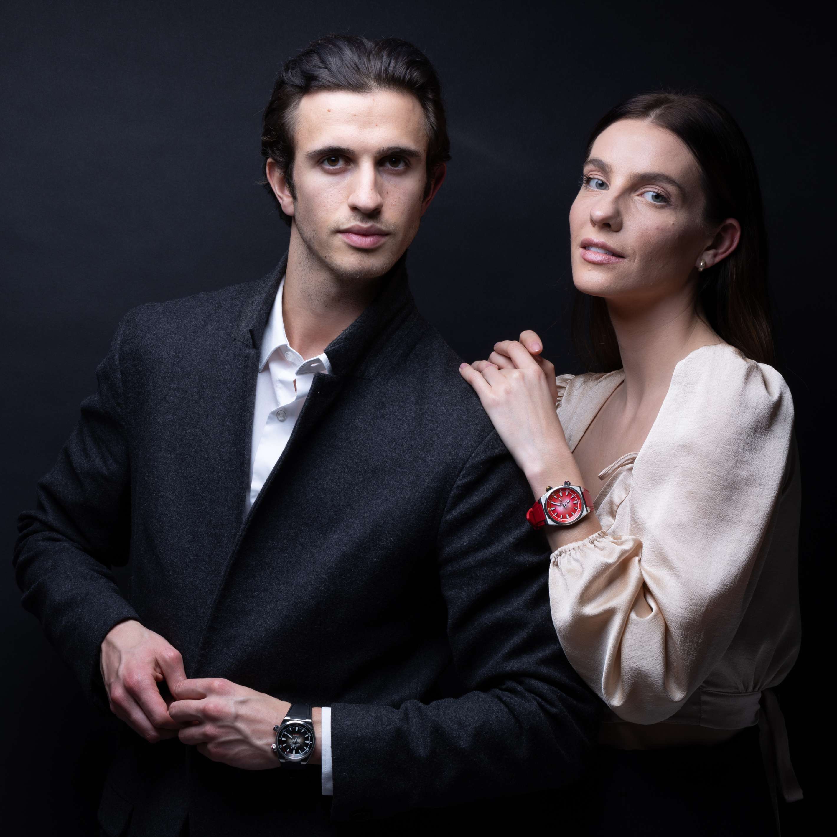 Man wearing a Midnight Black Edward Christopher luxury watch & dive watch and a woman wearing a Rose Red Edward Christopher luxury watch & dive watch
